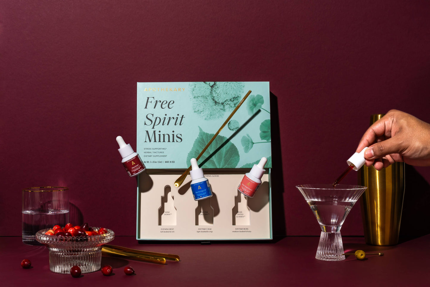 Free Spirit Minis packaging with cocktail ingredients on a dark red background