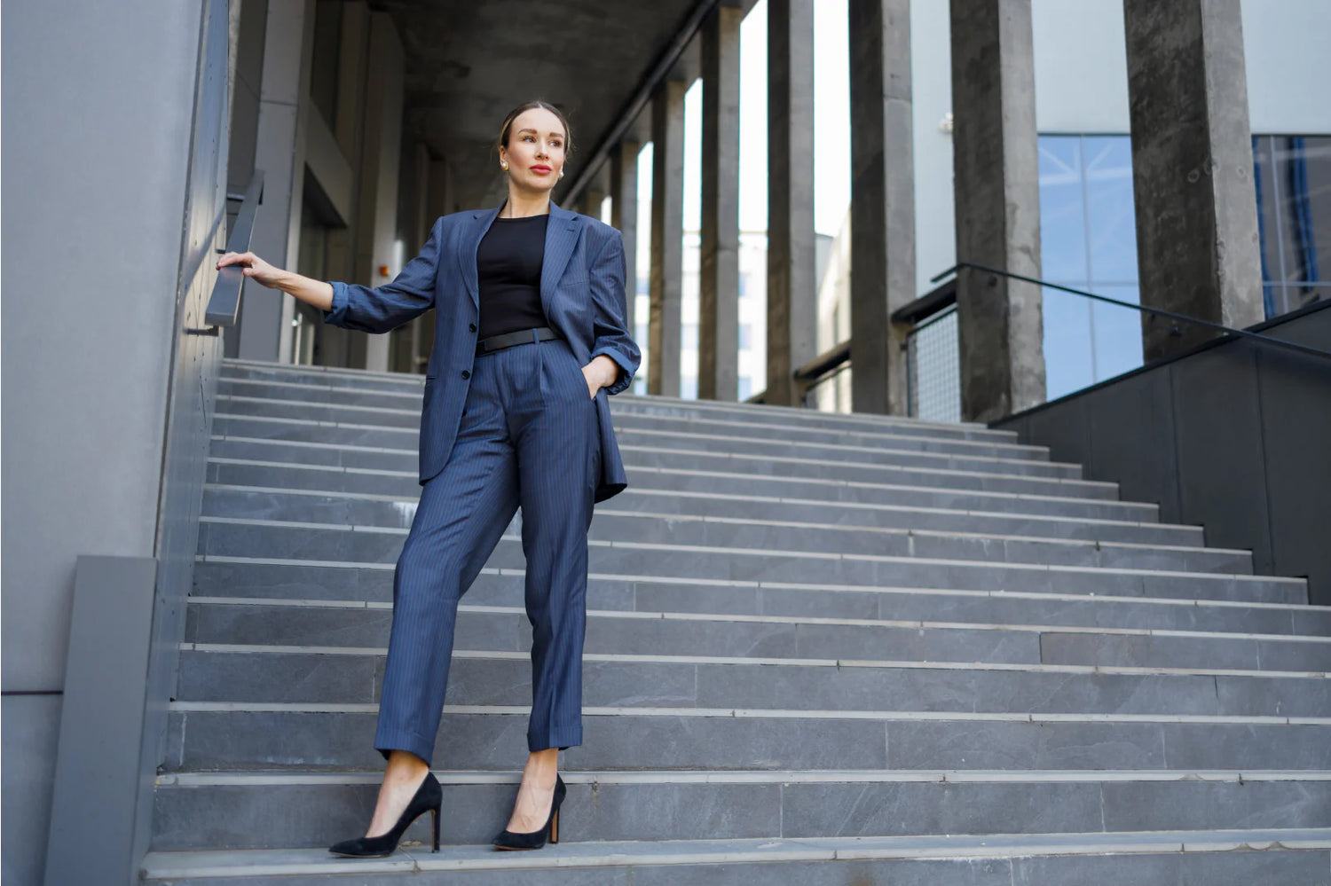 woman wearing a blazer and pants at and office building