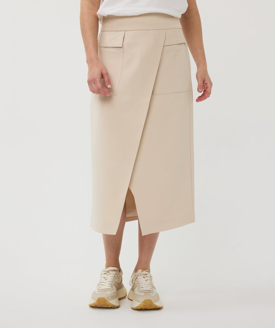 Beige skirt worn by a woman on a white background