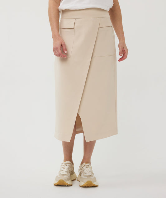 Beige skirt worn by a woman on a white background