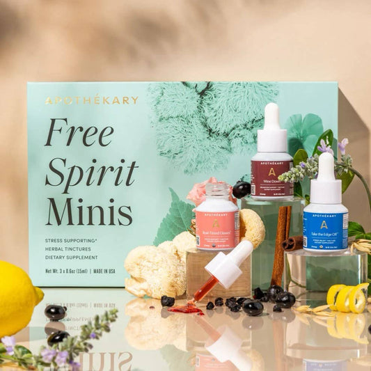 Athekary Free Spirit Minis packaging with various supplement bottles on a reflective surface.