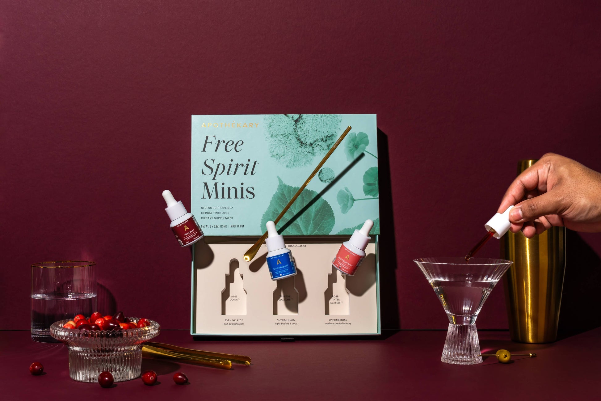 Free Spirit Minis packaging with cocktail ingredients on a dark red background