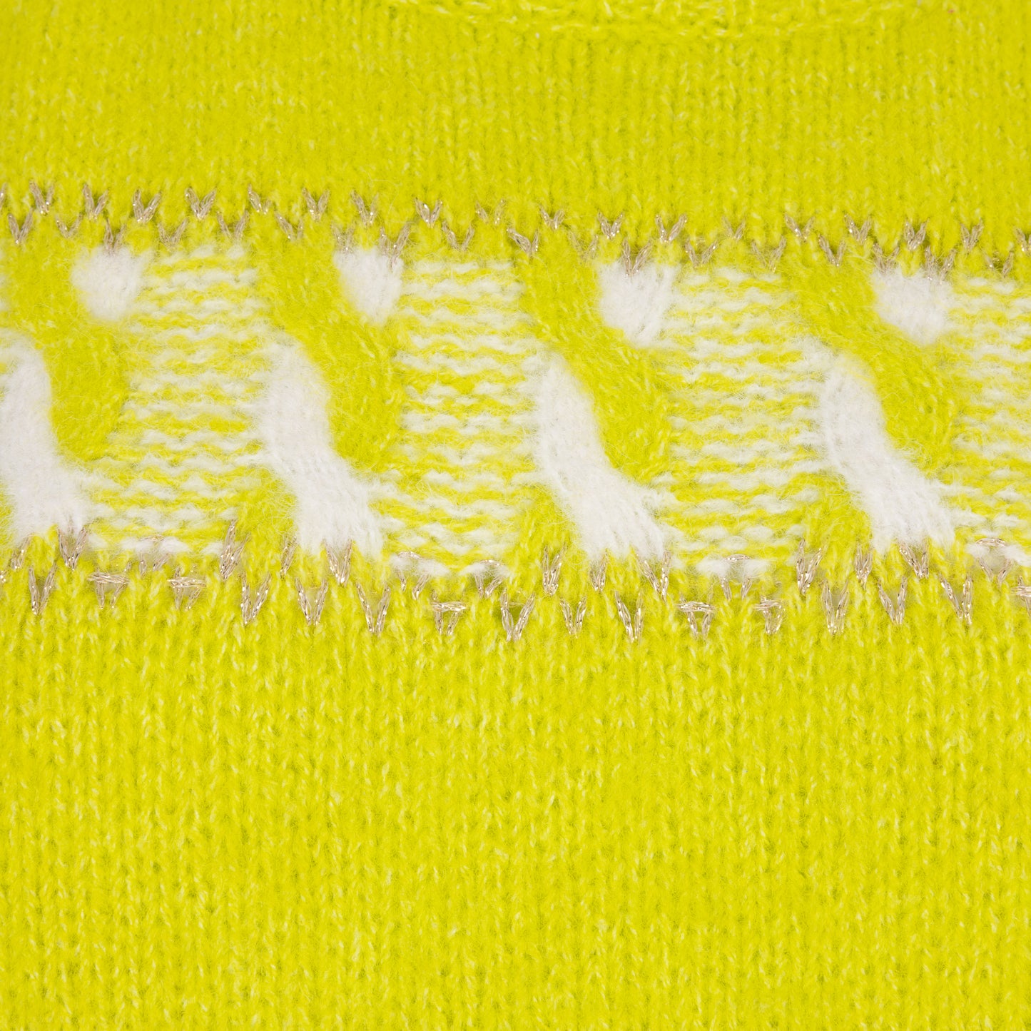 Close-up of a yellow fabric with white polka dots and silver thread